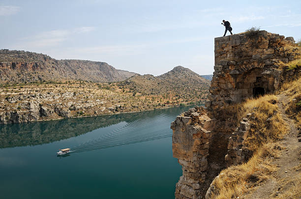 Rumkale and Firat River in Halfeti, Gaziantep, Turkey A photographer is shooting an image at top of old ruins. halfeti stock pictures, royalty-free photos & images
