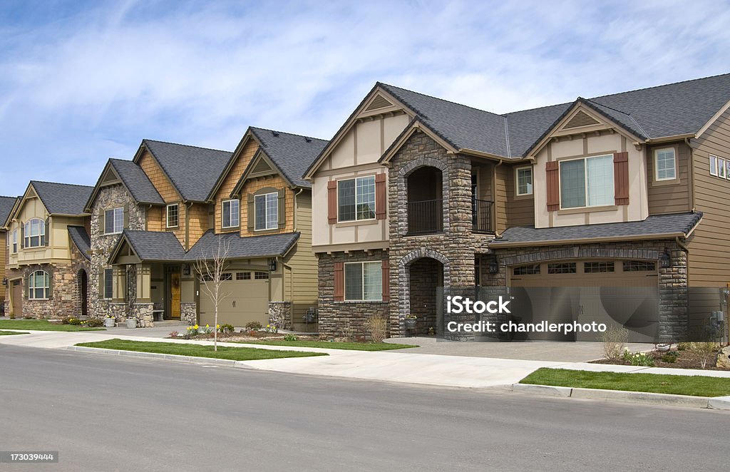 Three row houses with side walk Three row houses with landscape, sidewalks, cloudy sky.http://www.rosschandler.com/istock/01.jpg Row House Stock Photo