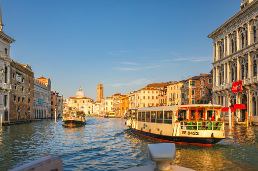 VENICE, ITALY - MARCH 4, 2023: Boats traffic on The Grand canal at a beautiful sunny morning.
