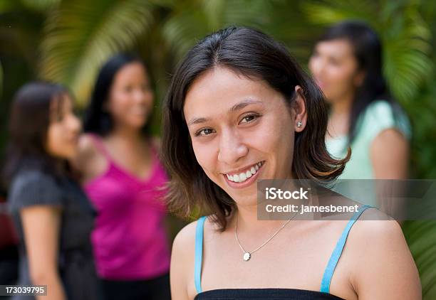 Latino Girl With Friends In Background Stock Photo - Download Image Now - 16-17 Years, 18-19 Years, Adult