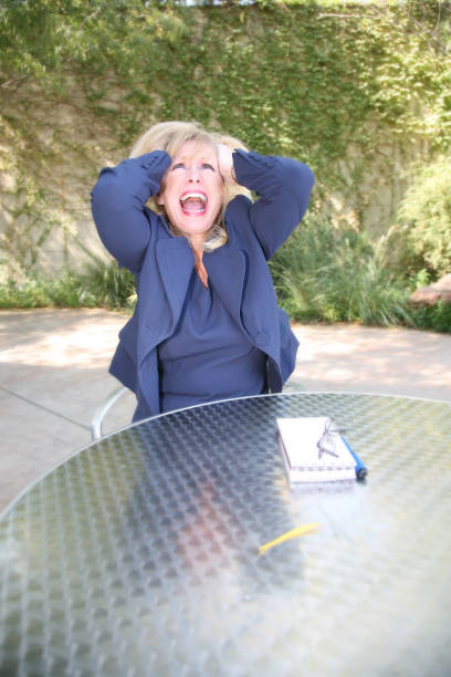 An adult woman with her hands on her head.See more from this series: