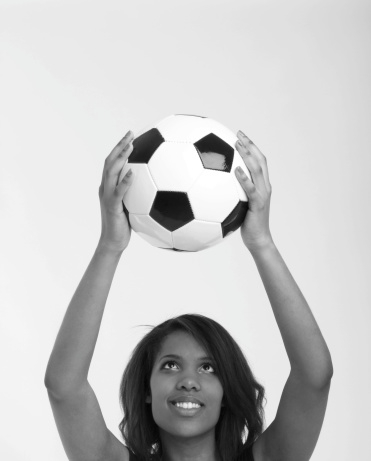A Young Woman Holding A Soccer Ball In Black and White. Copy Space.