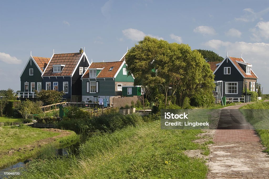 Rozewerf in Marken, The Netherlands "Rozewerf, A small communityon a warf in the town of Marken the Netherlands. An artificial dwelling hill (known as Terp, Wierde, Woerd, Warf, Warft, Werf, Wurt and V&#230;rft) is a mound, created to provide safe ground during high tide and river floods. These hills occur in the northern part of the Netherlands." Amsterdam Stock Photo