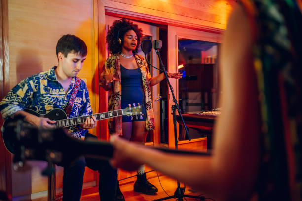 istock Band recording a song in a music studio. 1730409152