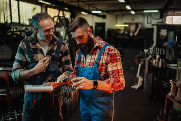 istock A senior engineer sharing experience to a young one during factory check-up. 1730410206