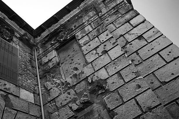 Shrapnel damaged building (black and white) stock photo
