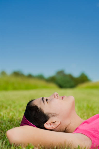 istock Side view of girl lying in grass and looking up 173043207