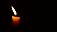 istock HD Moving single lit candle flame in the wind 173045878