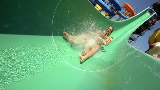 HD Super Slow-Mo: Mother And Daughter Sliding On Water Slide
