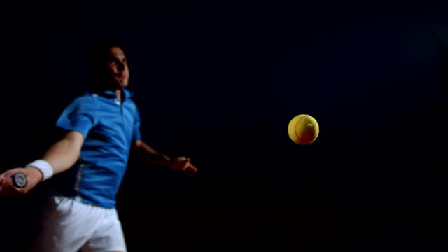 HD Super Slow-Mo: Tennis Player In Action At Night