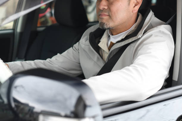 istock Middle-aged Asian man driving with a smile 1730498843