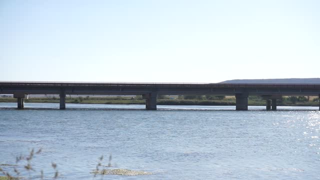 Vehicles crossing the bridge over the river