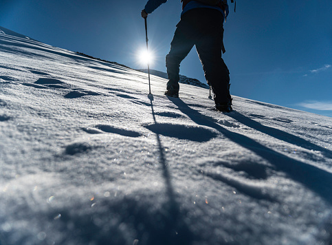 People in nature, man on winter hike in snowcapped mountain.