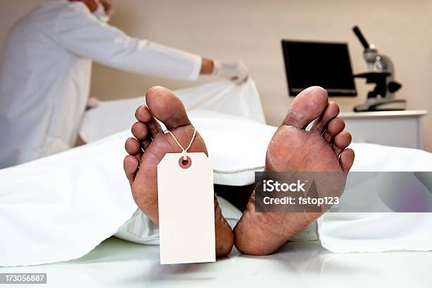 Mortician Coroner Covering Dead Body In Morgue Feet Toe Tag Stock Photo - Download Image Now