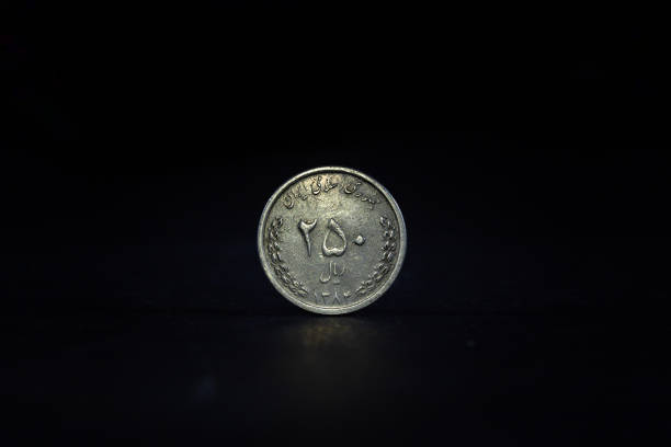 istock Selective blur on a 250 rials coin from Iran, isolated on a black background. IRR, or iranian rial, is the official currency and money of the islamic republic of Iran. 1730631487