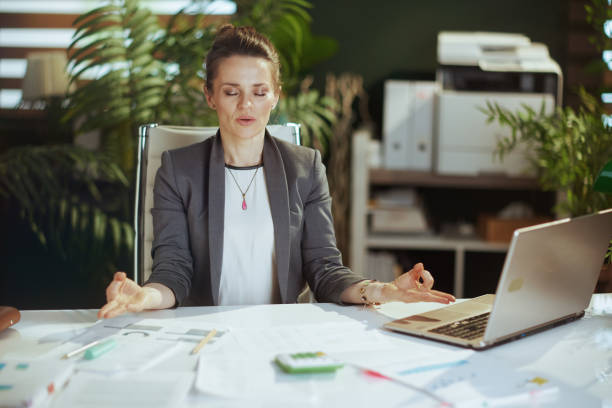 istock relaxed modern business woman at work with laptop meditating 1730650585