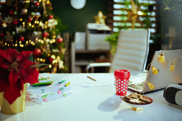 istock modern Christmas decorated green office with laptop 1730651121
