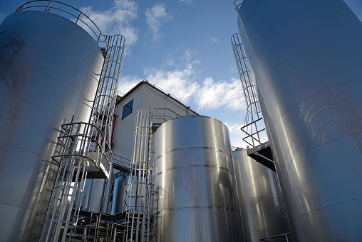 Stainless steel silos store milk products at a factory that manufactures hundreds of products
