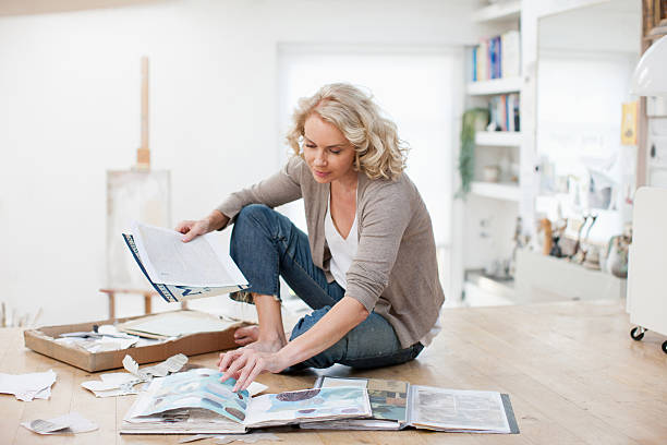 Woman with photograph album and scrapbook organization photos stock pictures, royalty-free photos & images