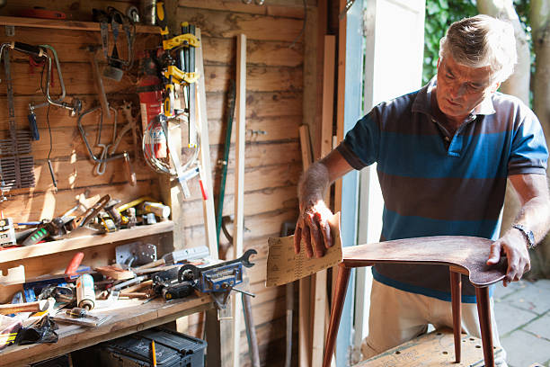 Man sanding wood in workshop  2590 stock pictures, royalty-free photos & images