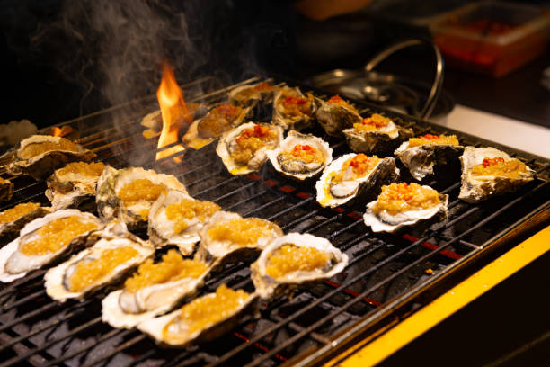 istock cooking charcoal grilled oysters with garlic sauce at horizontal composition 1730696894