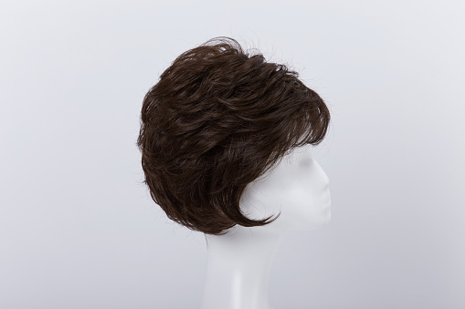 a wig on a mannequin with a white background