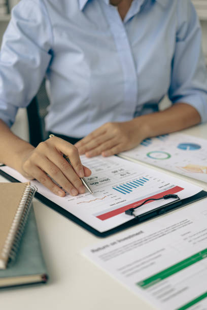 Auditor and accountant working in office Analyze financial data and accounting records with a calculator. Accounting companies provide financial and tax planning services. Close-up pictures