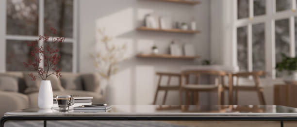 istock Copy space on a modern coffee table in a spacious modern living room. blurry background. 1730730990