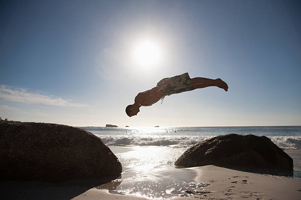 Man doing flip on beach  person falling backwards stock pictures, royalty-free photos & images