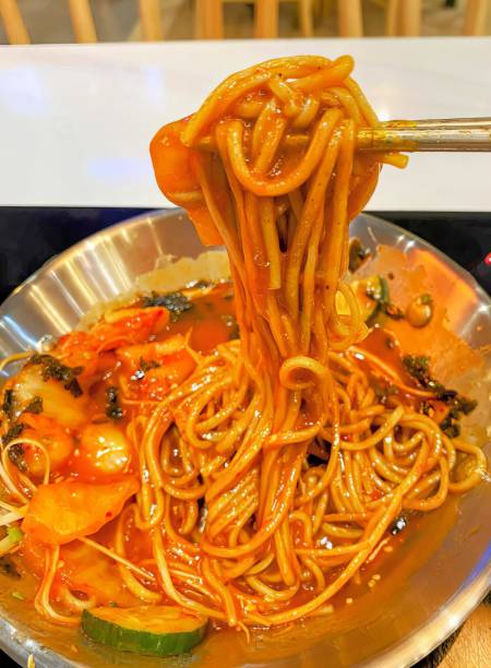 istock a bowl of noodles with a spoon. 1730815947