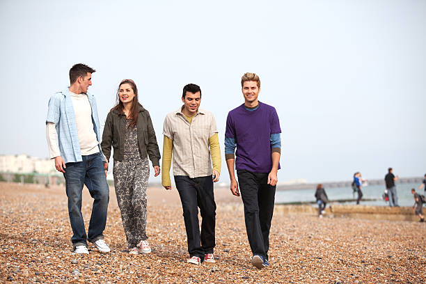 Friends on the beach 4 beautiful friends walking on the beach brighton england stock pictures, royalty-free photos & images