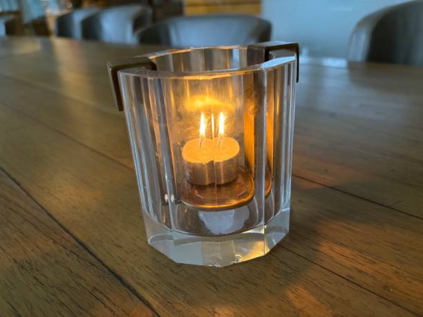 istock Small candle lit in a glass 1730854963