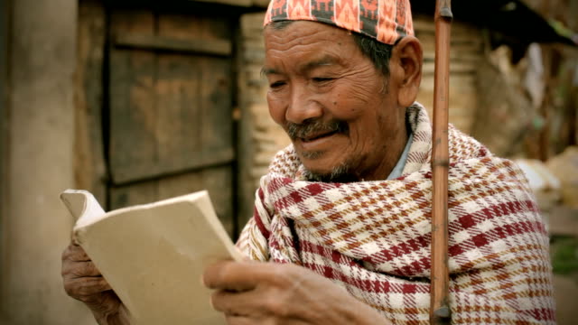 Asian people: A senior man reading book