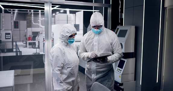 Sterile Semiconductor Manufacturing Factory And Workers In Coveralls