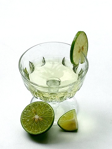 Lemons juice placed on a white background. Lemons juice helps relieve headaches. Close -up shot of the lemons juice.