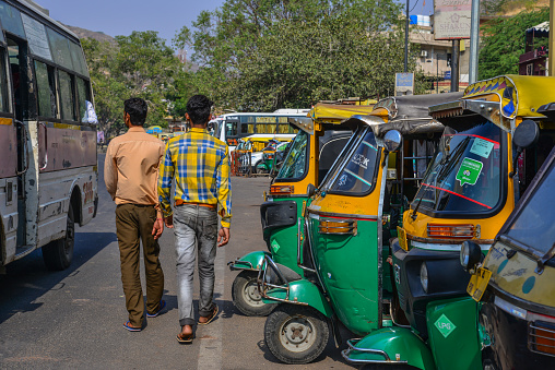 Jaipur, India - Nov 3, 2017. Tuk tuk taxis waiting for passengers on street near Amber Fort in Jaipur, India.