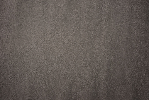 Close-up of gray crumpled paper texture background.