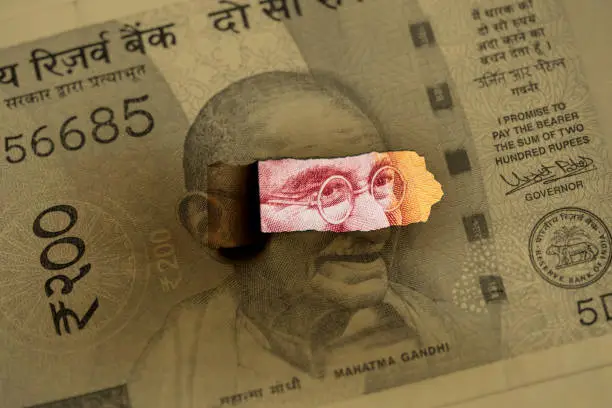 Mahatma Gandhi peeking on Indian paper currency.