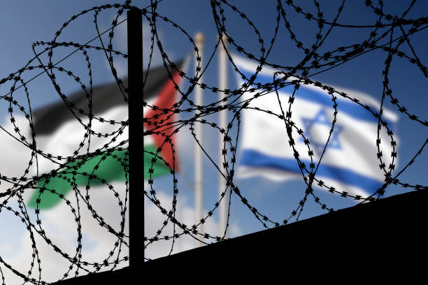 Flags of Israel and Palestine behind the barbed wire Flaggen von Israel und Palästina hinter dem Stacheldraht palestinian territories stock pictures, royalty-free photos & images