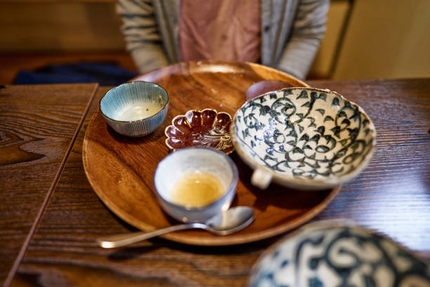 Asian woman eating a vegan lunch at a vegan restaurant.