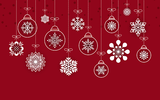 Hanging christmas baubles and snowflakes on a red background