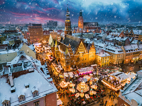 View of the old town square of Wrocław, Poland, with the traditional Christmas Market and snowfall