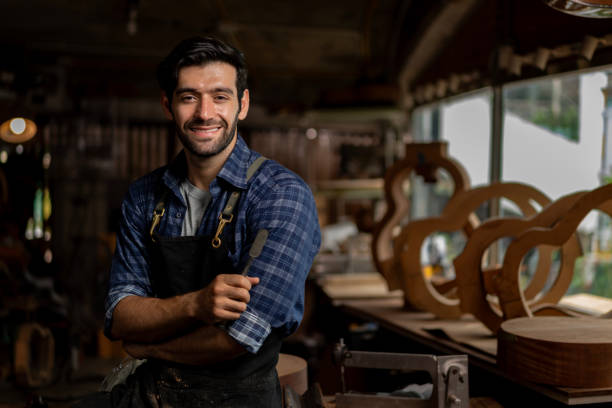 istock Acoustic Guitar Luthier Smiling in Workshop Portrait 1730955430