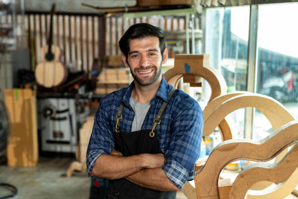 istock Acoustic Guitar Luthier Smiling in Workshop Portrait 1730957060