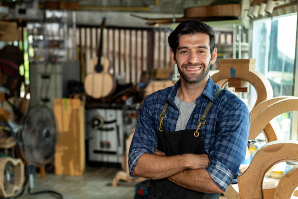istock Acoustic Guitar Luthier Smiling in Workshop Portrait 1730957198
