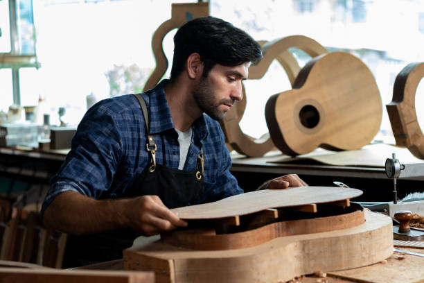 istock Guitar Luthier Ensures Back and Body Match in Mold 1730962104