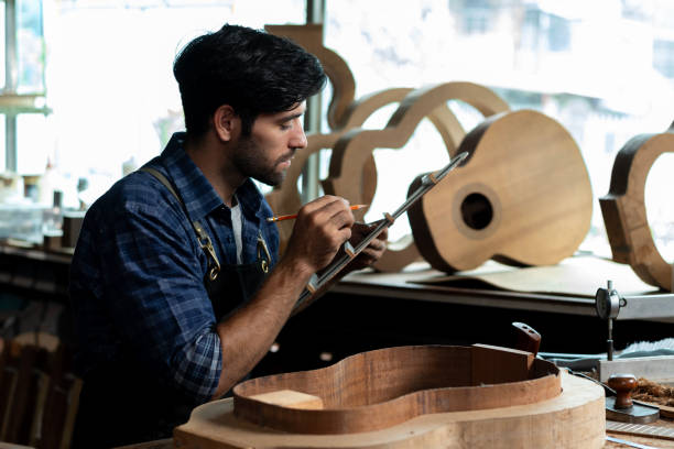 istock Guitar Luthier Ensures Back and Body Match in Mold 1730962109