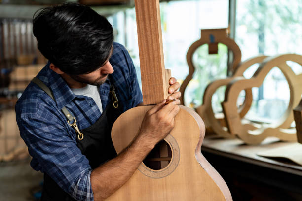 istock Guitar Luthier Aligns Guitar Neck on Body with Precision Ruler 1730962628