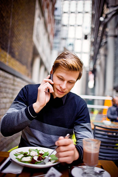 istock Young Man with Mobile Having Healthy Lunch in Outdoor Cafe 173096706