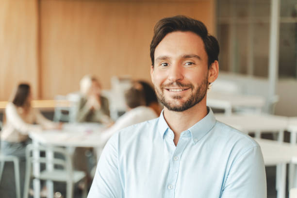 istock Handsome smiling middle aged businessman, manager standing in modern office. Confident bearded salesman looking at camera. Successful business concept 1730967636